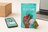 Plain Jane flower beside a phone map, laptop, and shipping box for an online cannabis buying guide