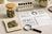 CBN hemp flower samples beside a magnifying glass and cannabinoid lab report