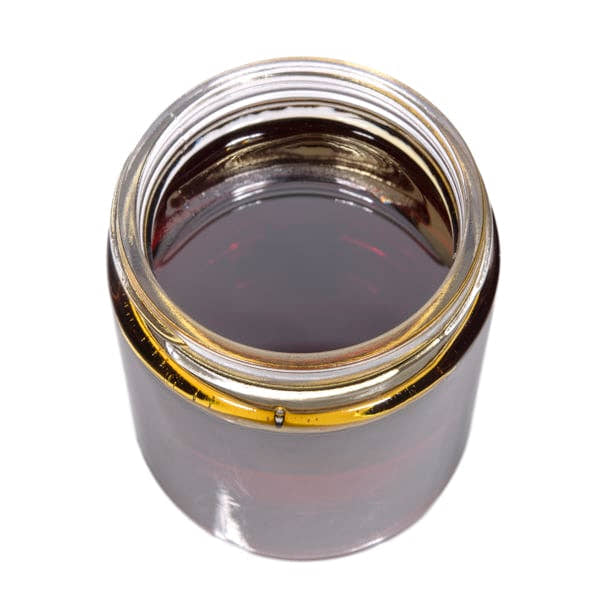 Crystal resistant CBD distillate in unbranded jars; appearance varies by batch
