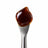 Crystal-Resistant CBD Distillate on a stainless steel concentrate tool against a clean white background