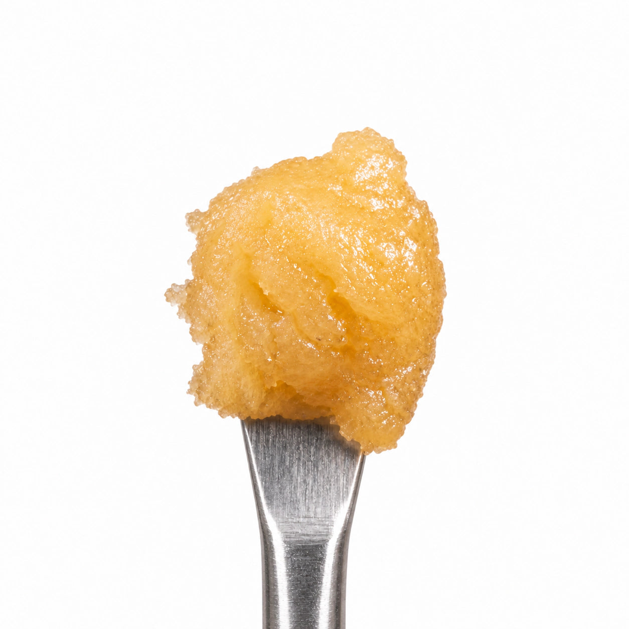 THCA Badder on a stainless steel concentrate tool against a clean white background