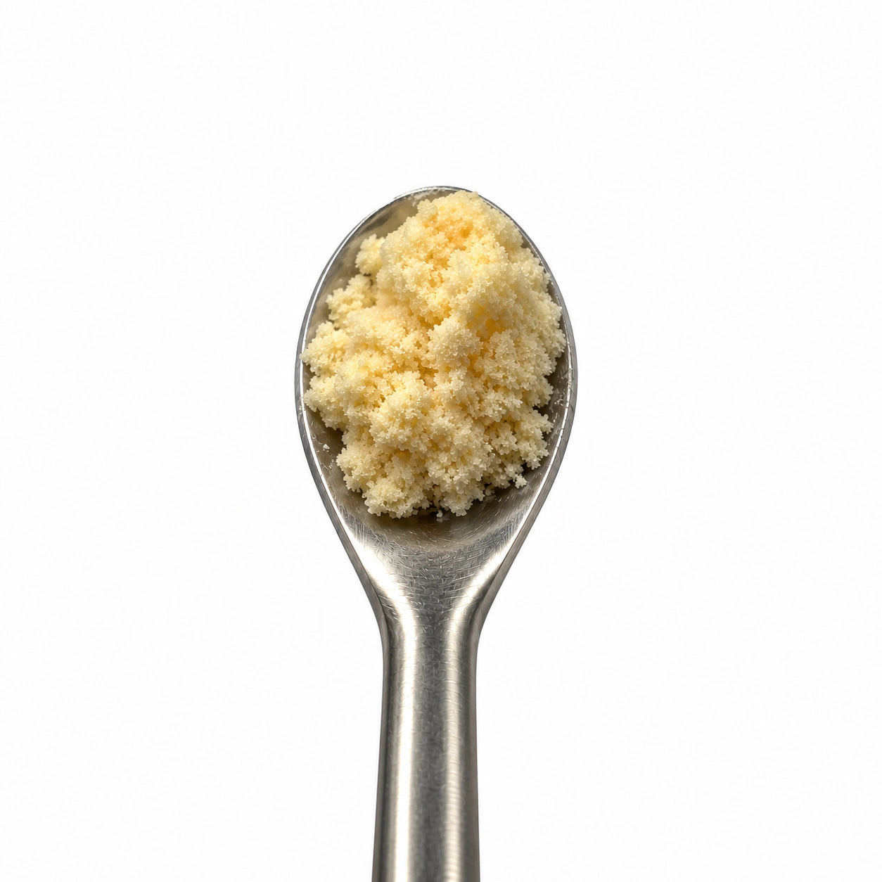 THCA Crumble on a stainless steel concentrate tool against a clean white background