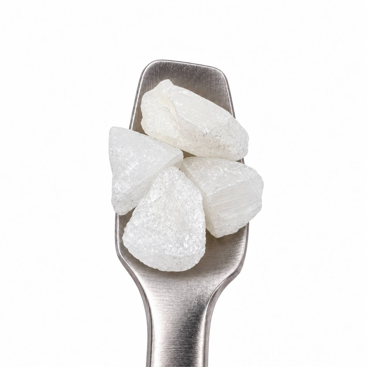 THCA diamonds on a stainless steel concentrate tool against a clean white background