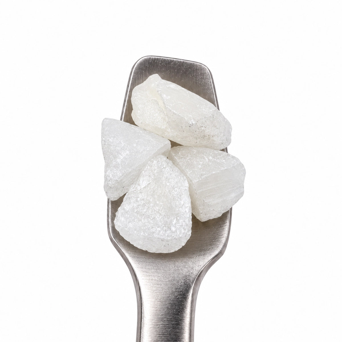 THCA diamonds on a stainless steel concentrate tool against a clean white background