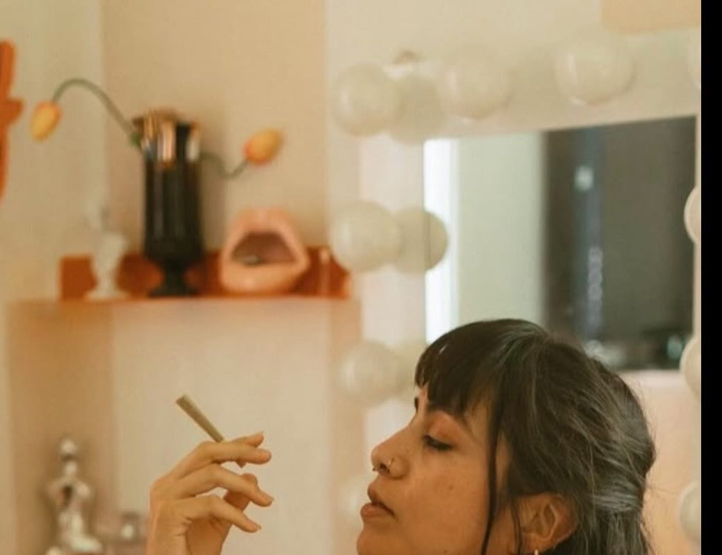 Person relaxing at home with a hemp joint