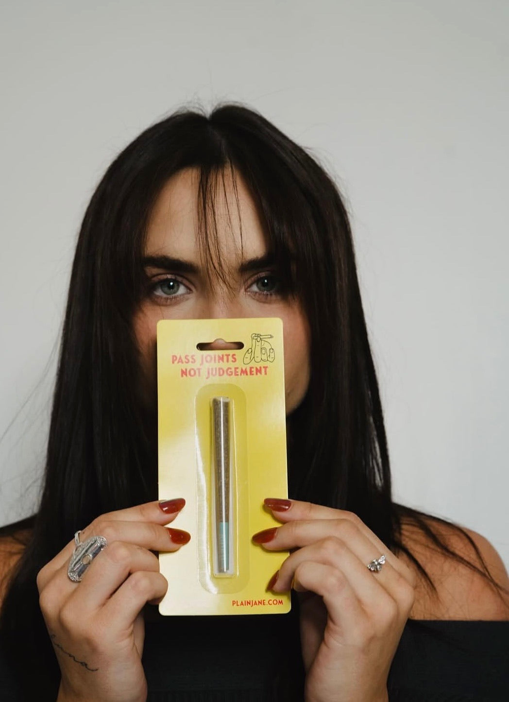 Plain Jane customer holding a Pass Joints Not Judgement case