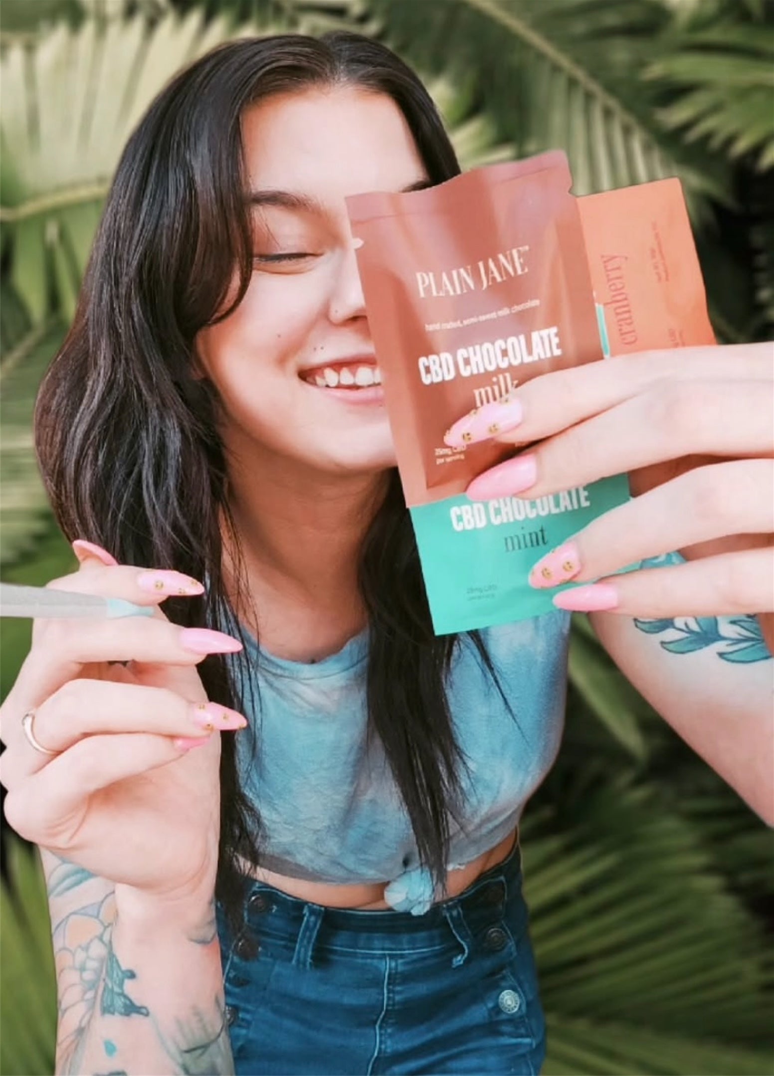 Smiling Plain Jane customer holding branded chocolate packaging
