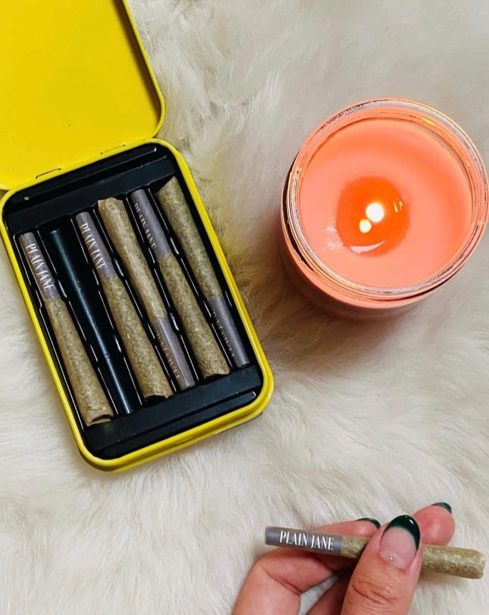 Candle and pre-roll in an evening tabletop composition