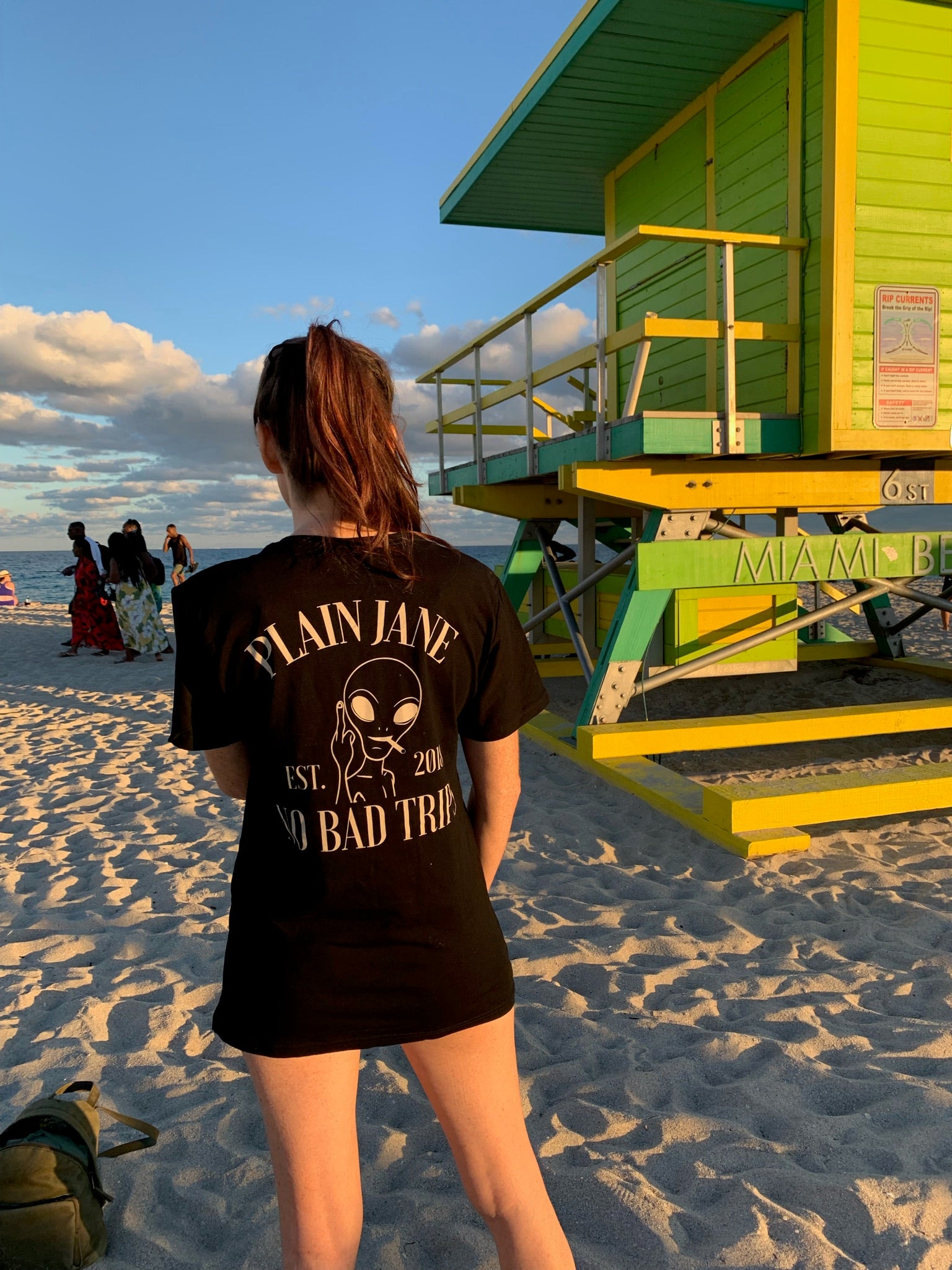 Plain Jane customer wearing a branded shirt at the beach