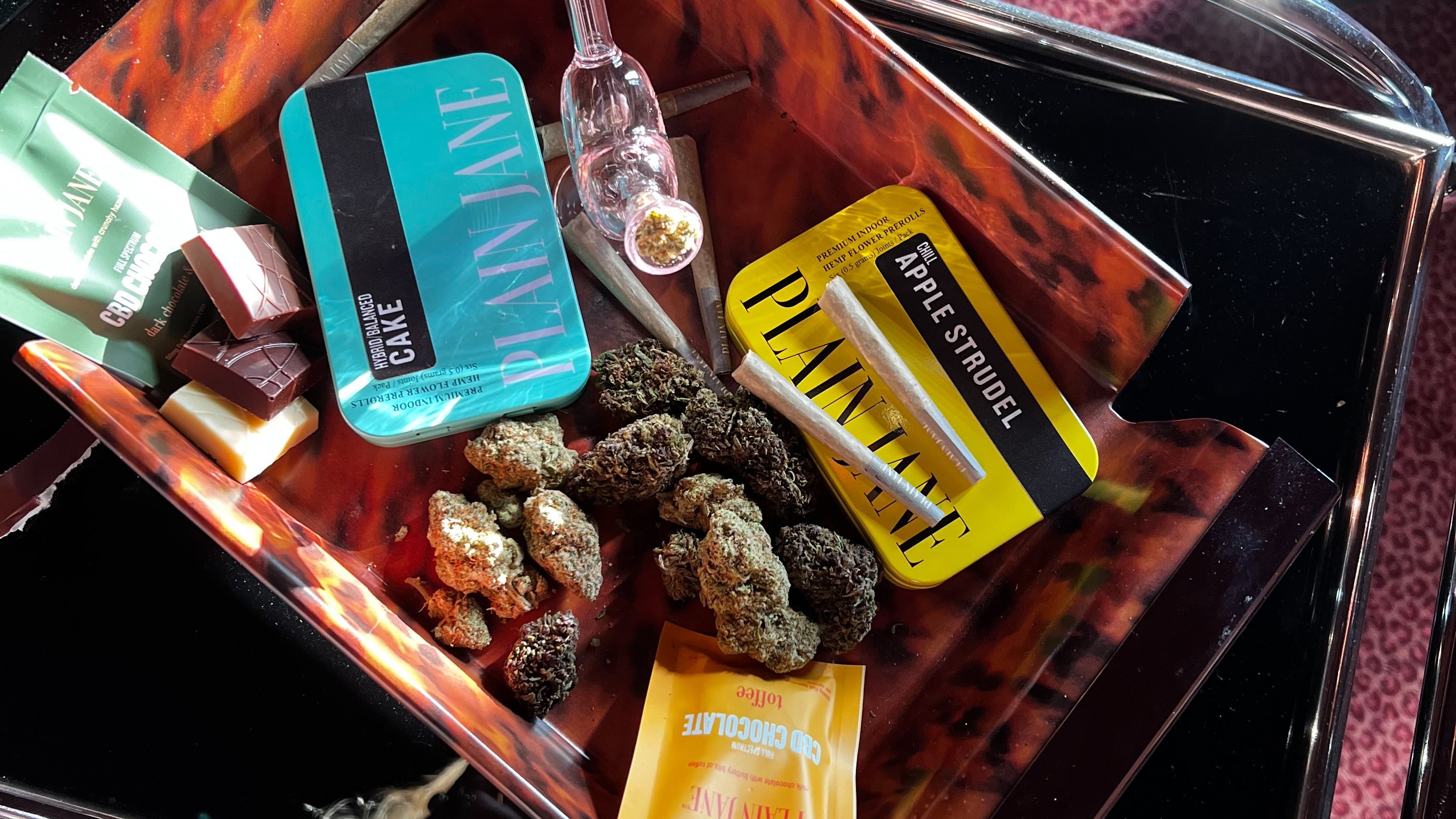 Plain Jane flower, pre-rolls, and hemp products arranged on a vintage cart