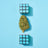 Cannabis flower arranged on a blue background between geometric blocks